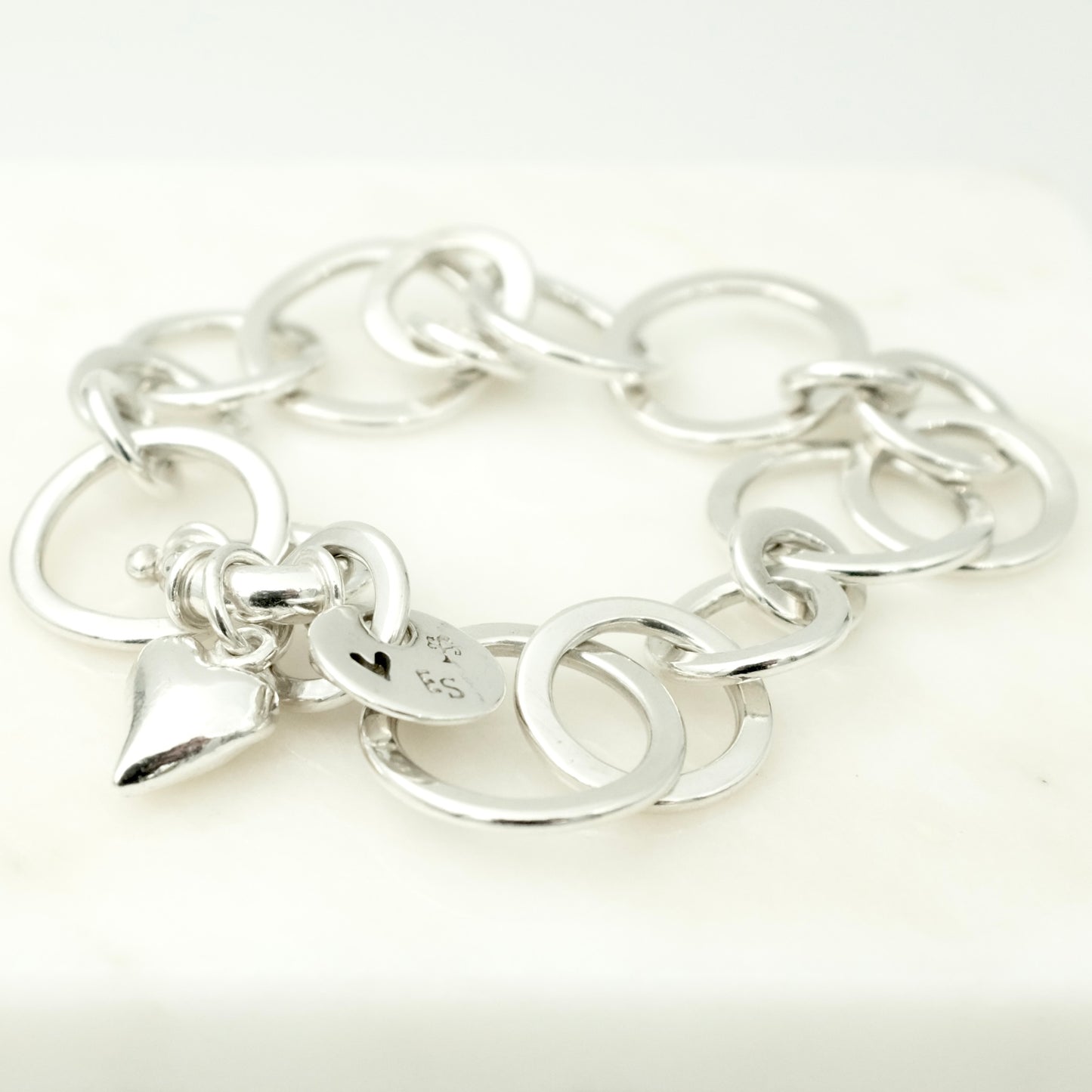 Flattened link bracelet with heart charm